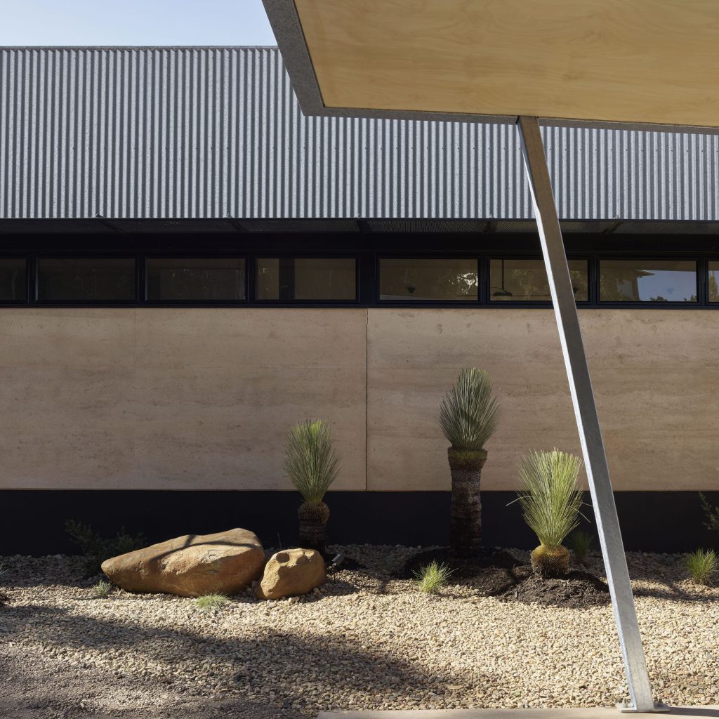 Rammed earth and corrugated steel facade