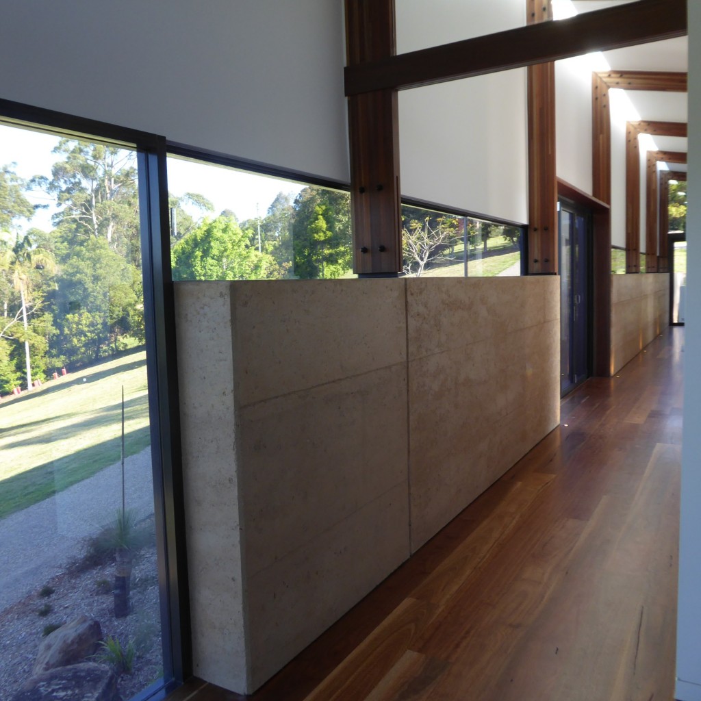 Hallway with low rammed earth walls
