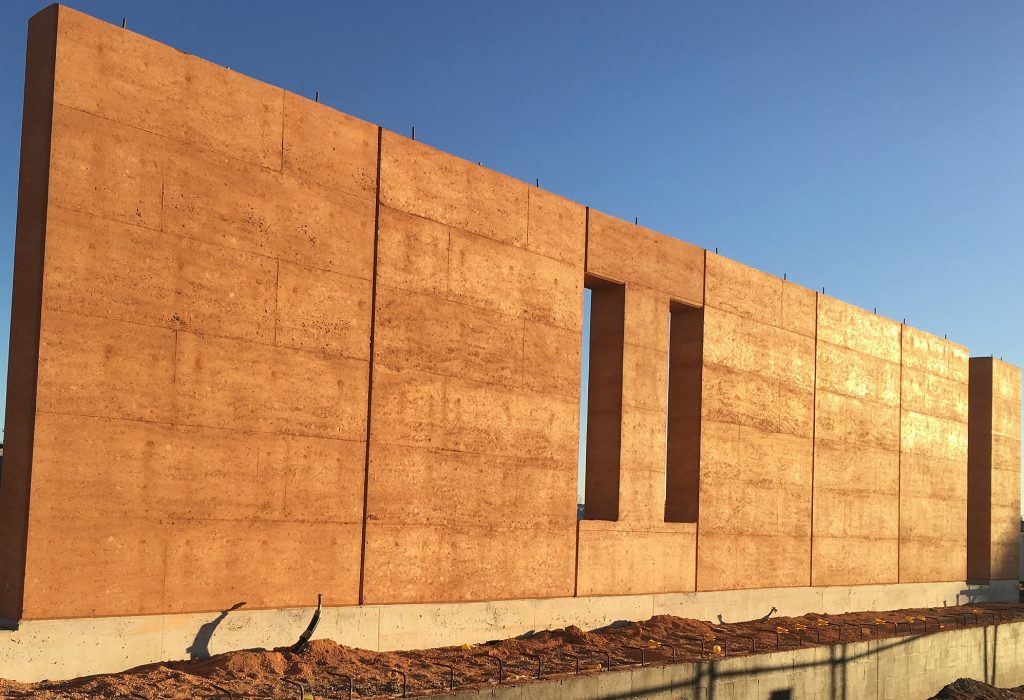 New rammed earth wall at sunset