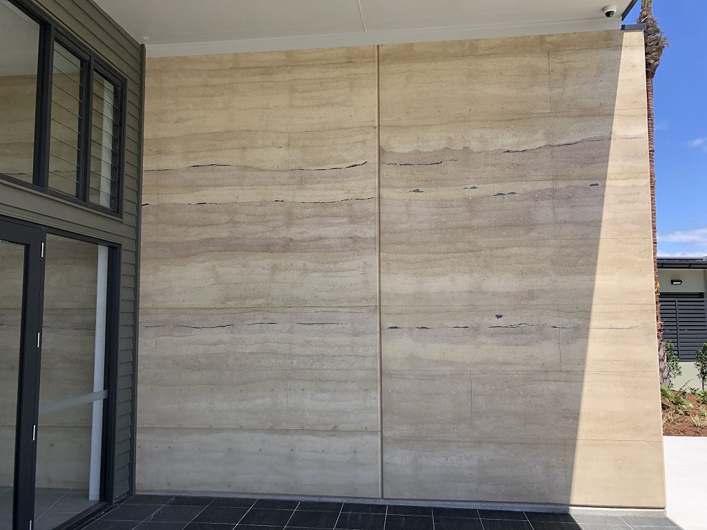 Rammed earth feature entry wall