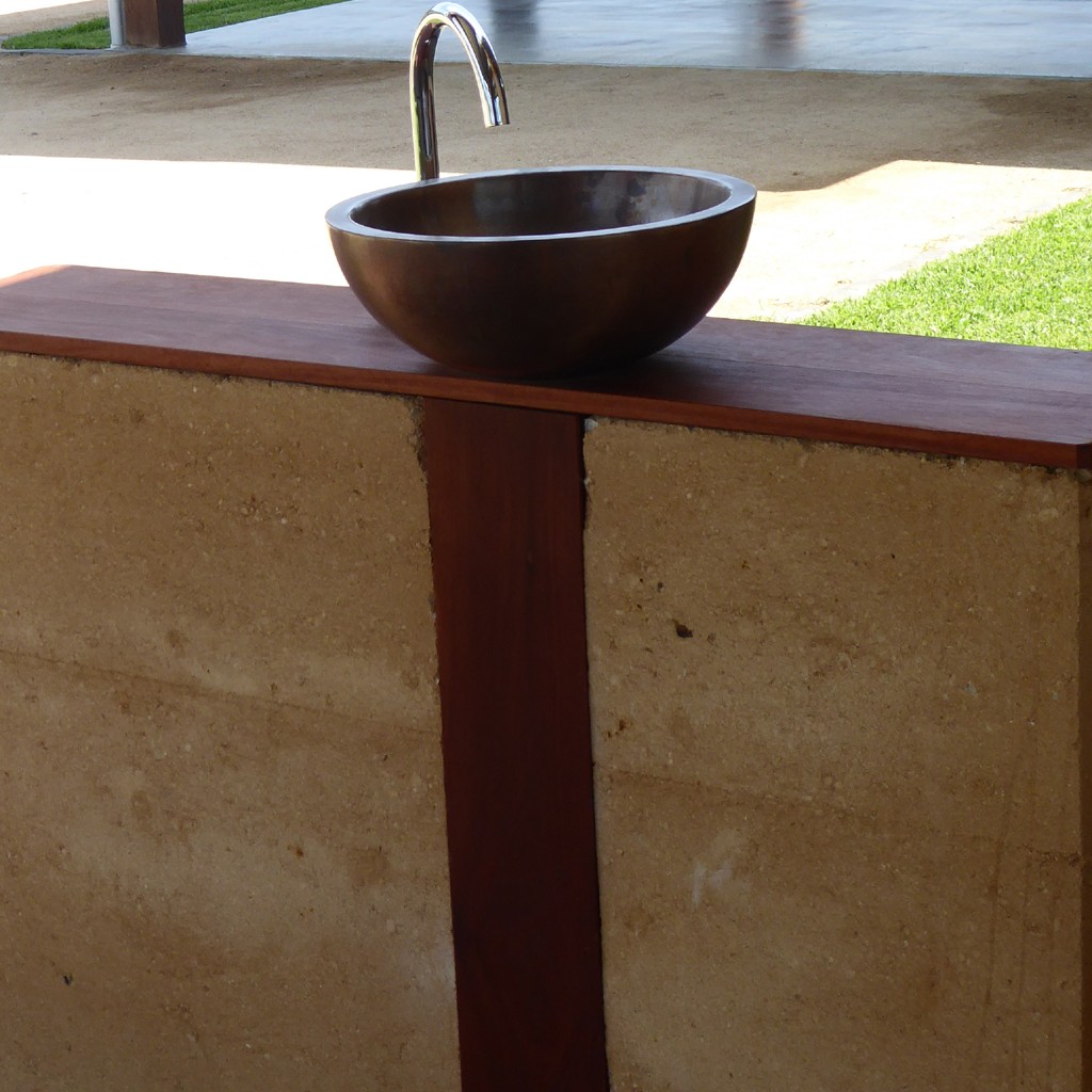 Wash bowl on rammed earth wall