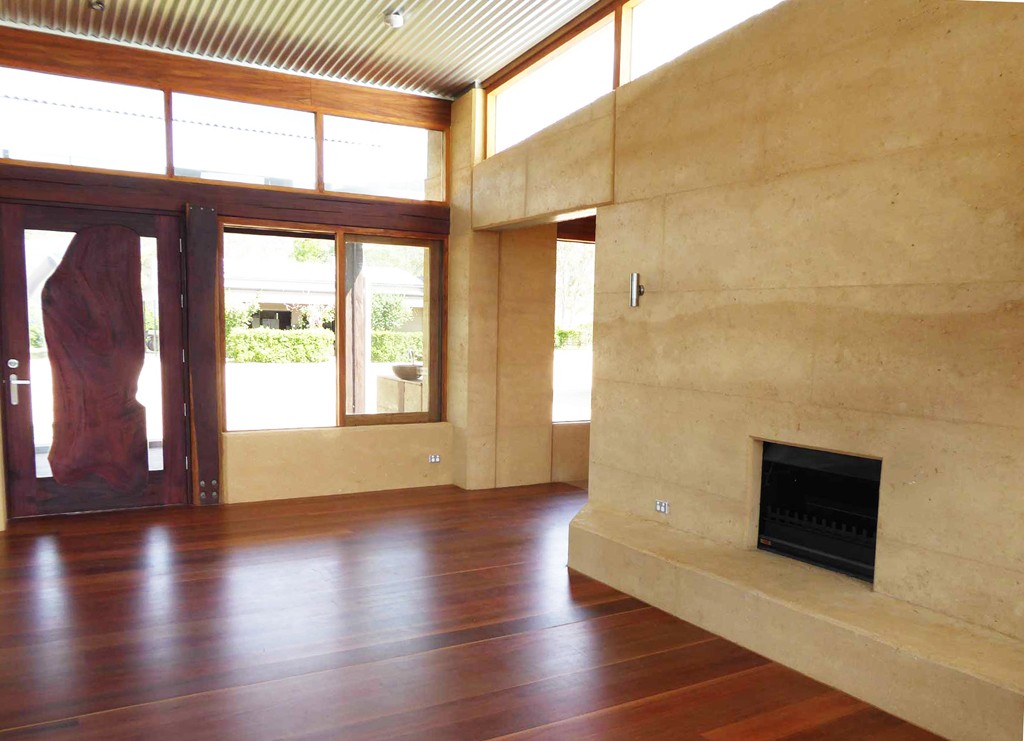fireplace and hearth in rammed earth wall