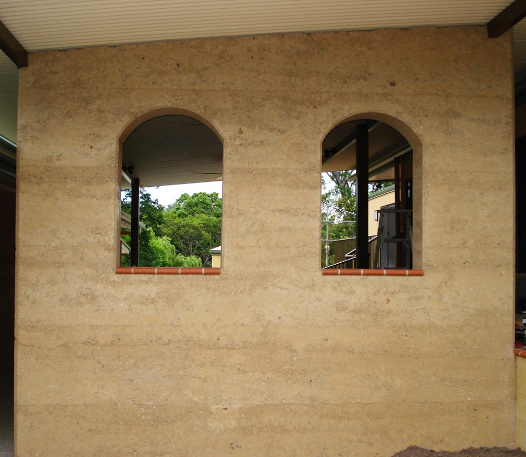 rammed earth arched windows